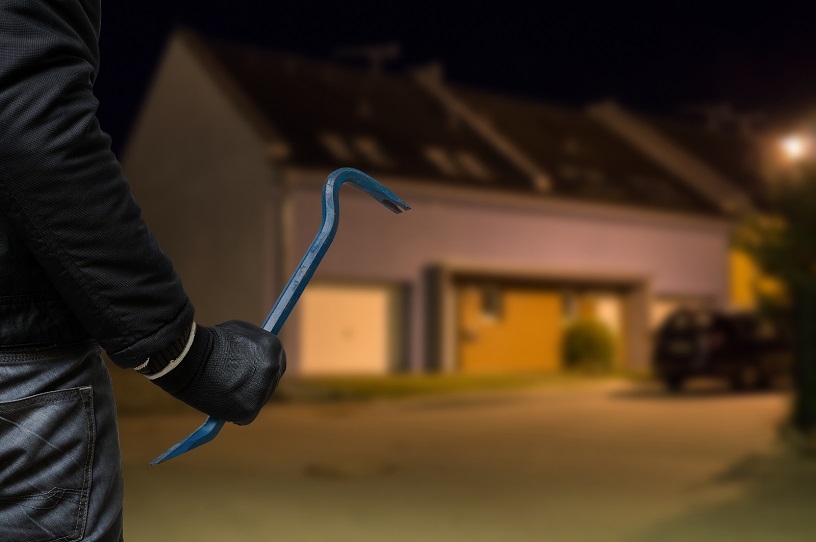 A burglar approaching a garage