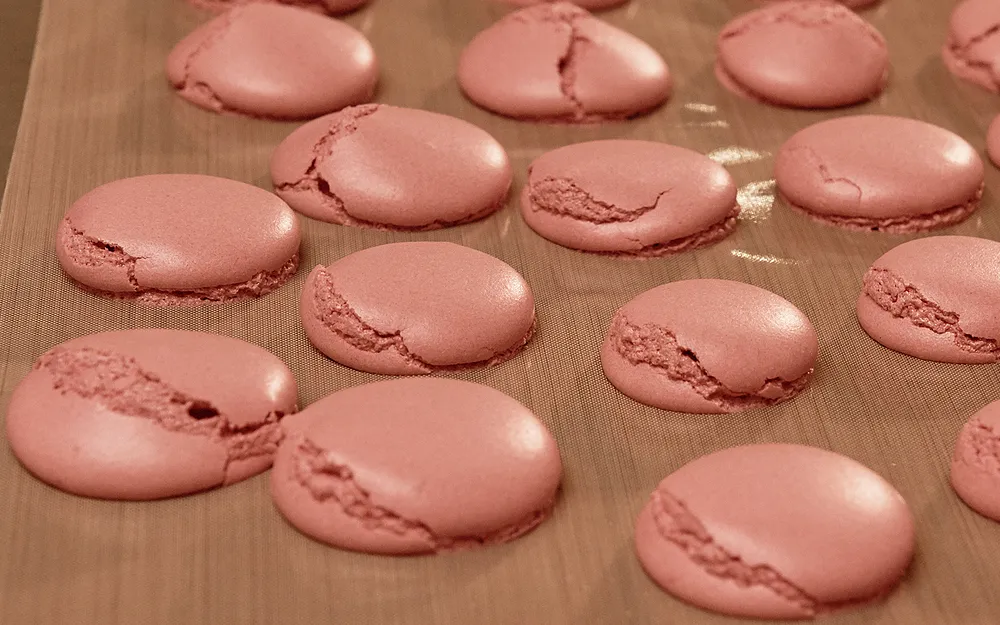 macaron shells with cracks in them