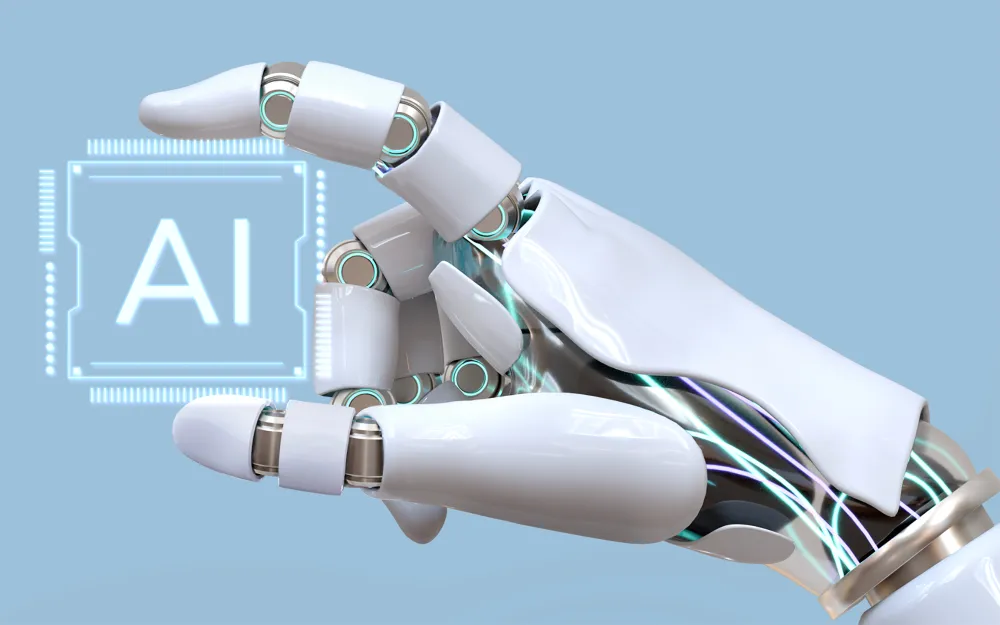 robot hand holding sign reading 'AI'