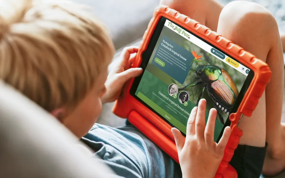 child read Bug Parc website on kid friendly tablet