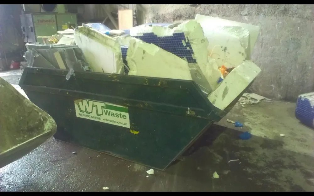 A skip overflowing with general waste.